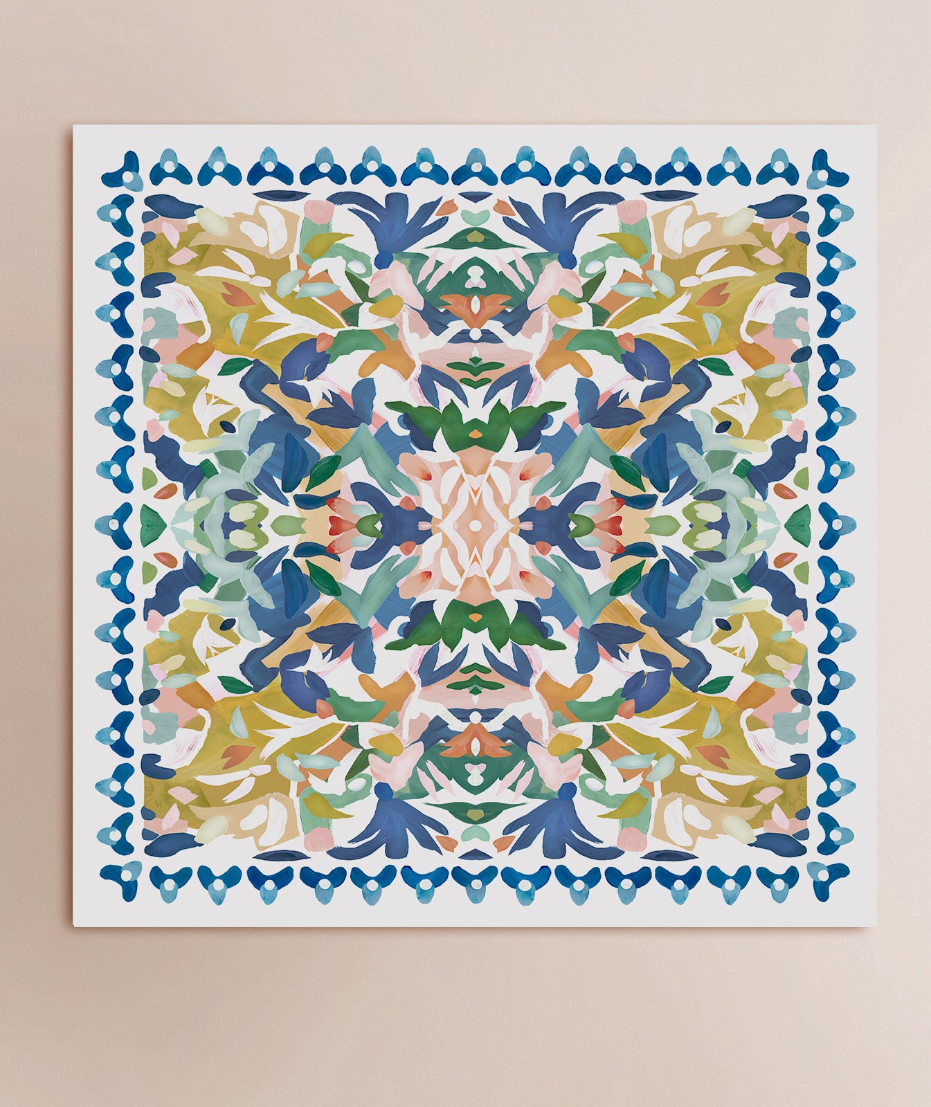 An abstract kaleidoscopic art print in blue, yellow, green and pink displayed on a solid background.