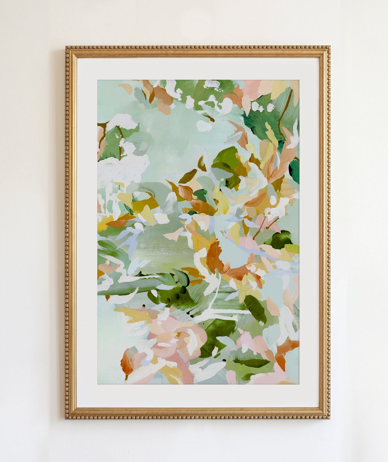 A gold beaded frame with green abstract painting in lush greens, pinks, burnt umber, browns and yellows.