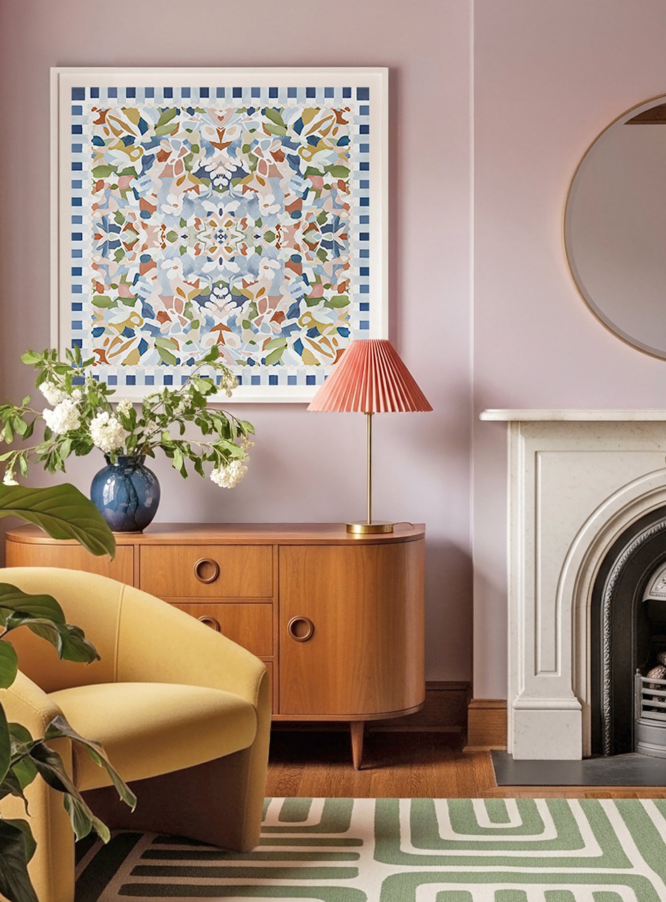 Living room featuring a large square, abstract and floral art print featuring blue, green, light pink, and terracotta colors displayed in a white frame above a cabinet.