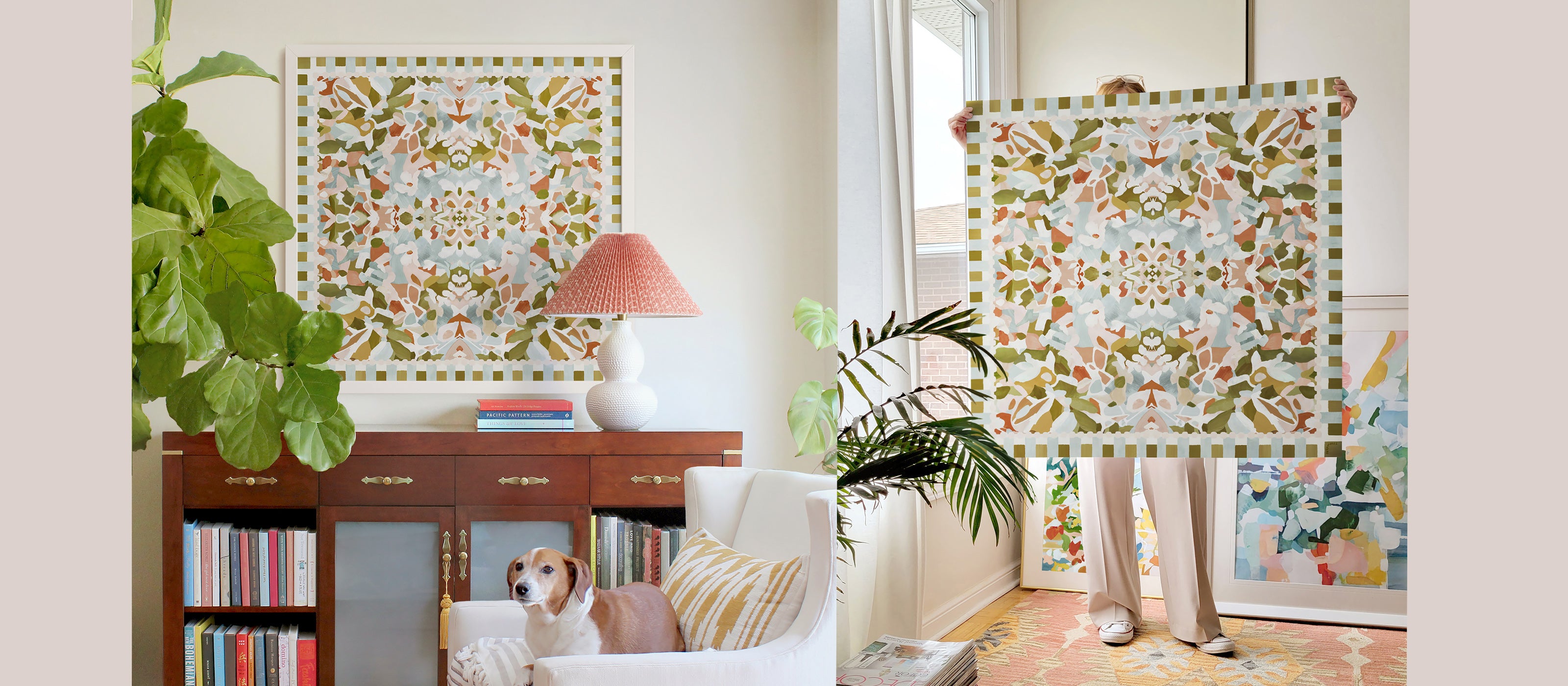 Large square, symmetrical abstract art in olive green, light pink, light sage blue and terracotta colors displayed above a bookcase cabinet with a dog on white accent chair. Next to it is a person holding the same art in a bright room.