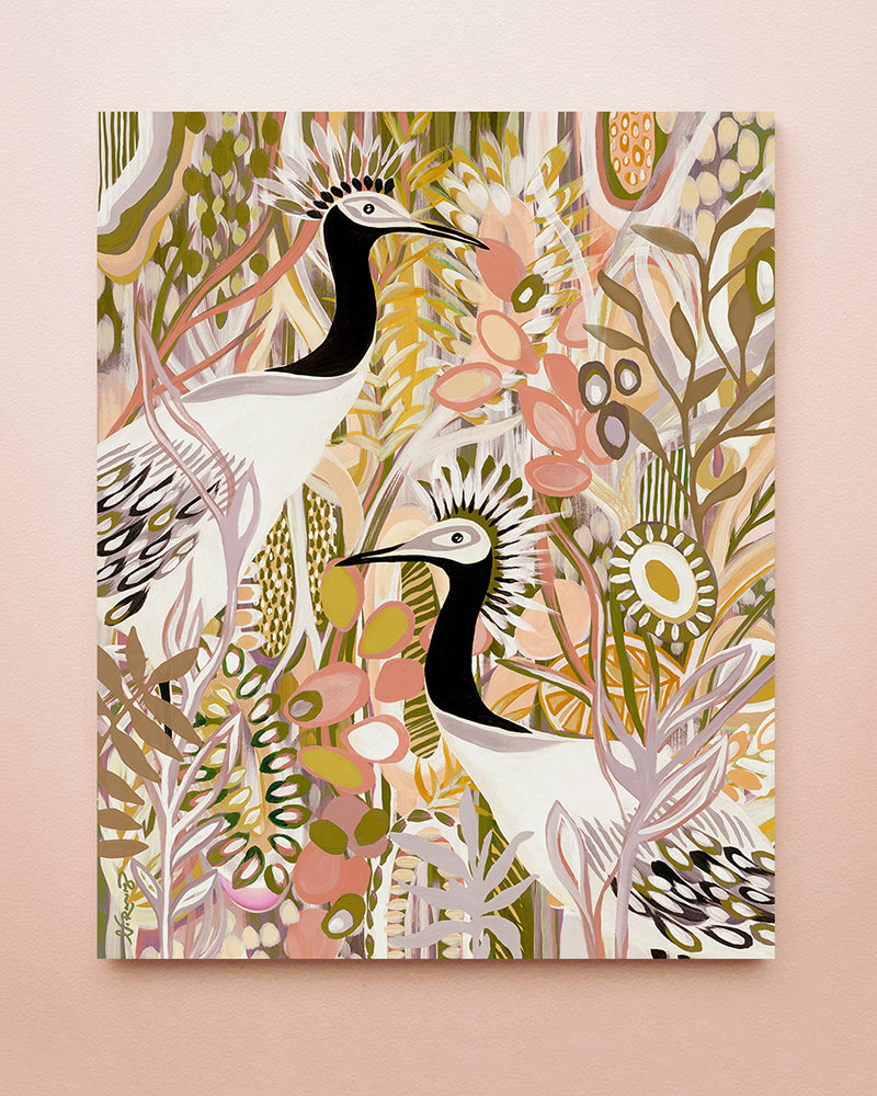 A fine art print featuring a floral design in pink, yellow and green along with two white and black birds, displayed on a solid background.